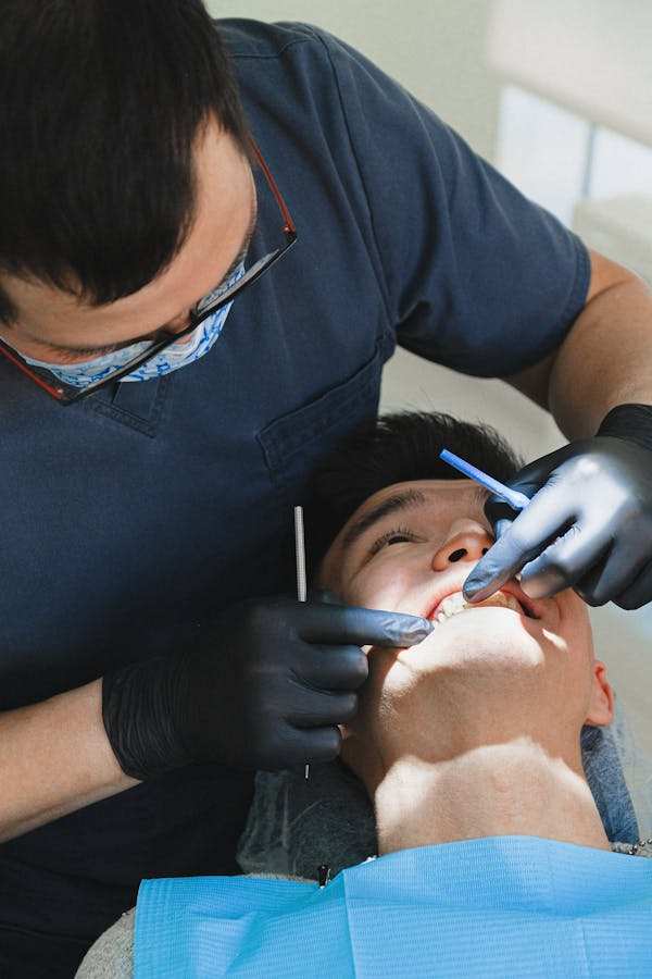 a dentist checking the patients teeth