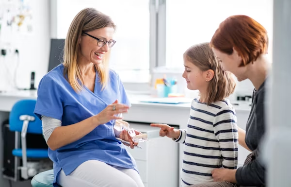 a dentist teaching a kid about dental health