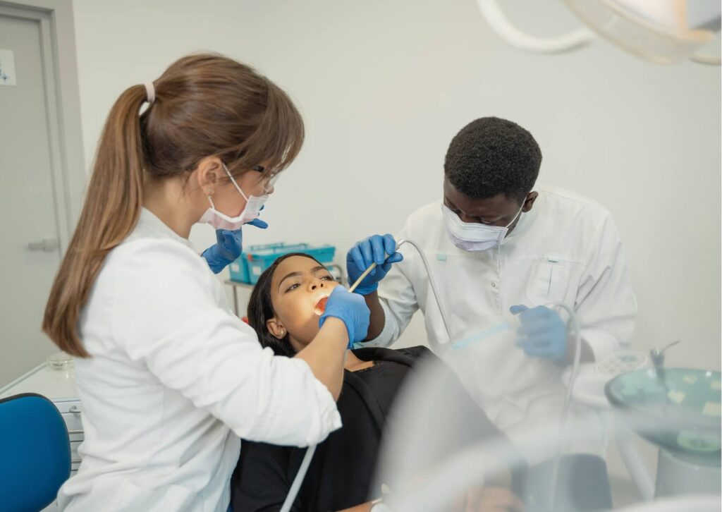Dental professionals examining a patient during treatment, highlighting the importance of monitoring oral health and potential dental effects associated with Ozempic use.