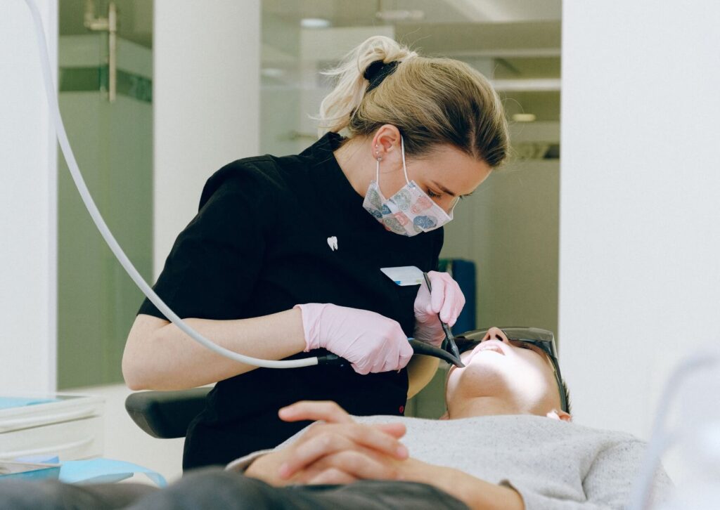 Dentist examining a patient's tooth to diagnose a cracked tooth and determine the best treatment for the damage.