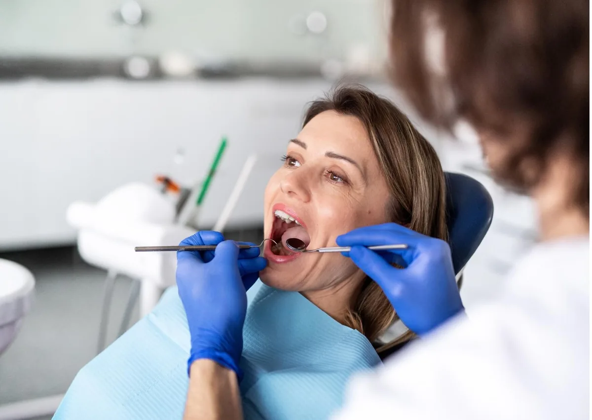 Dentist examining a patient’s teeth for signs of cavities and tooth decay during a dental checkup.