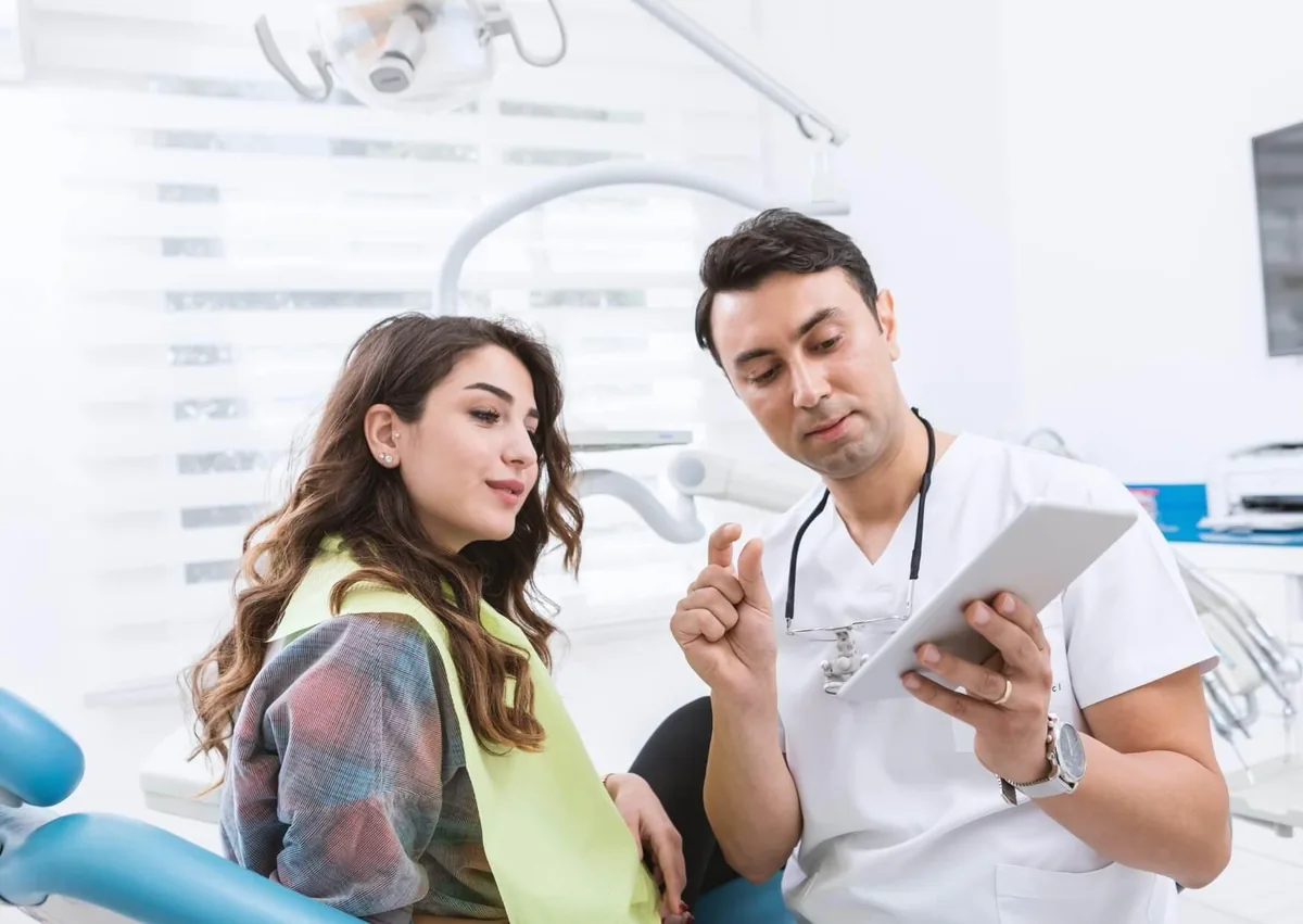 Dentist discussing preventive dental care and oral health recommendations with a patient.